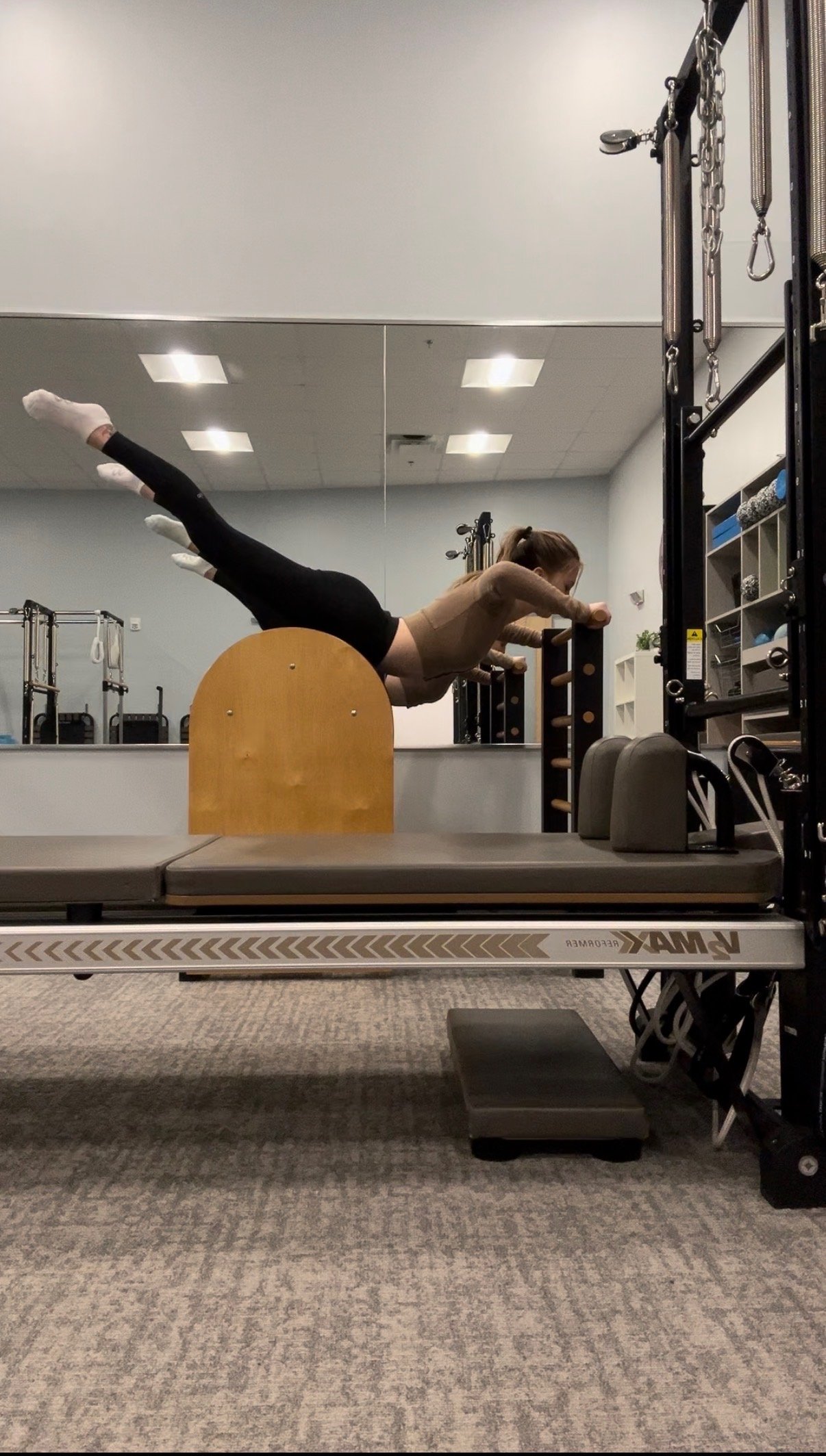 Catherine in a superman extension on the spine corrector